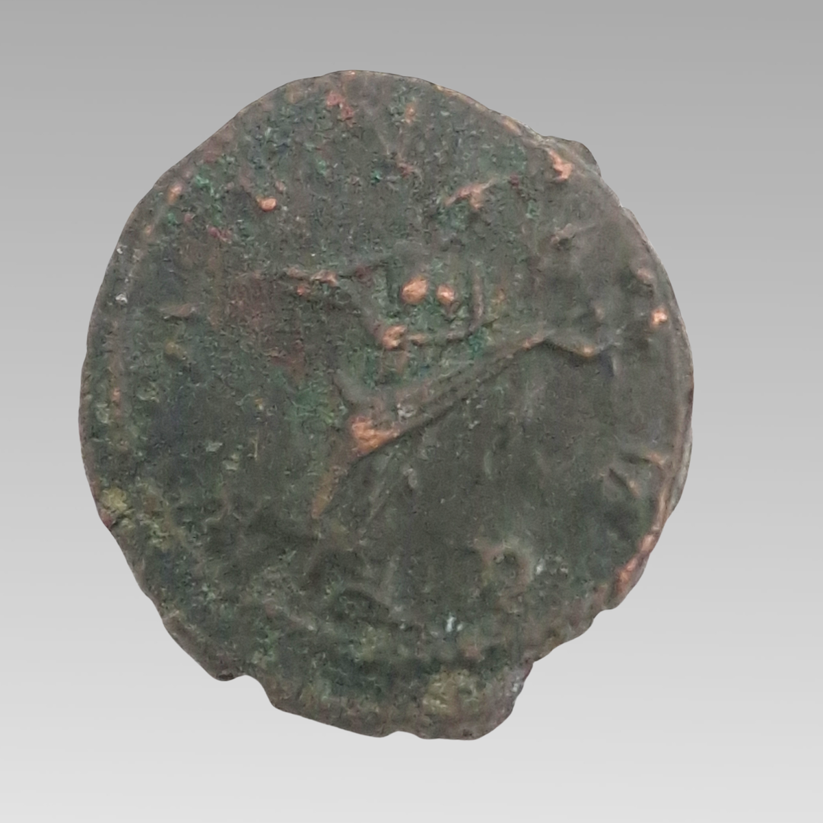 Reverse of ancient Roman antoninianus showing worn design and green-brown ancient patina.