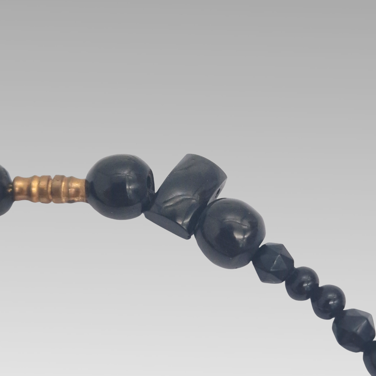 Close-up of Victorian Whitby jet beads and screw fastening